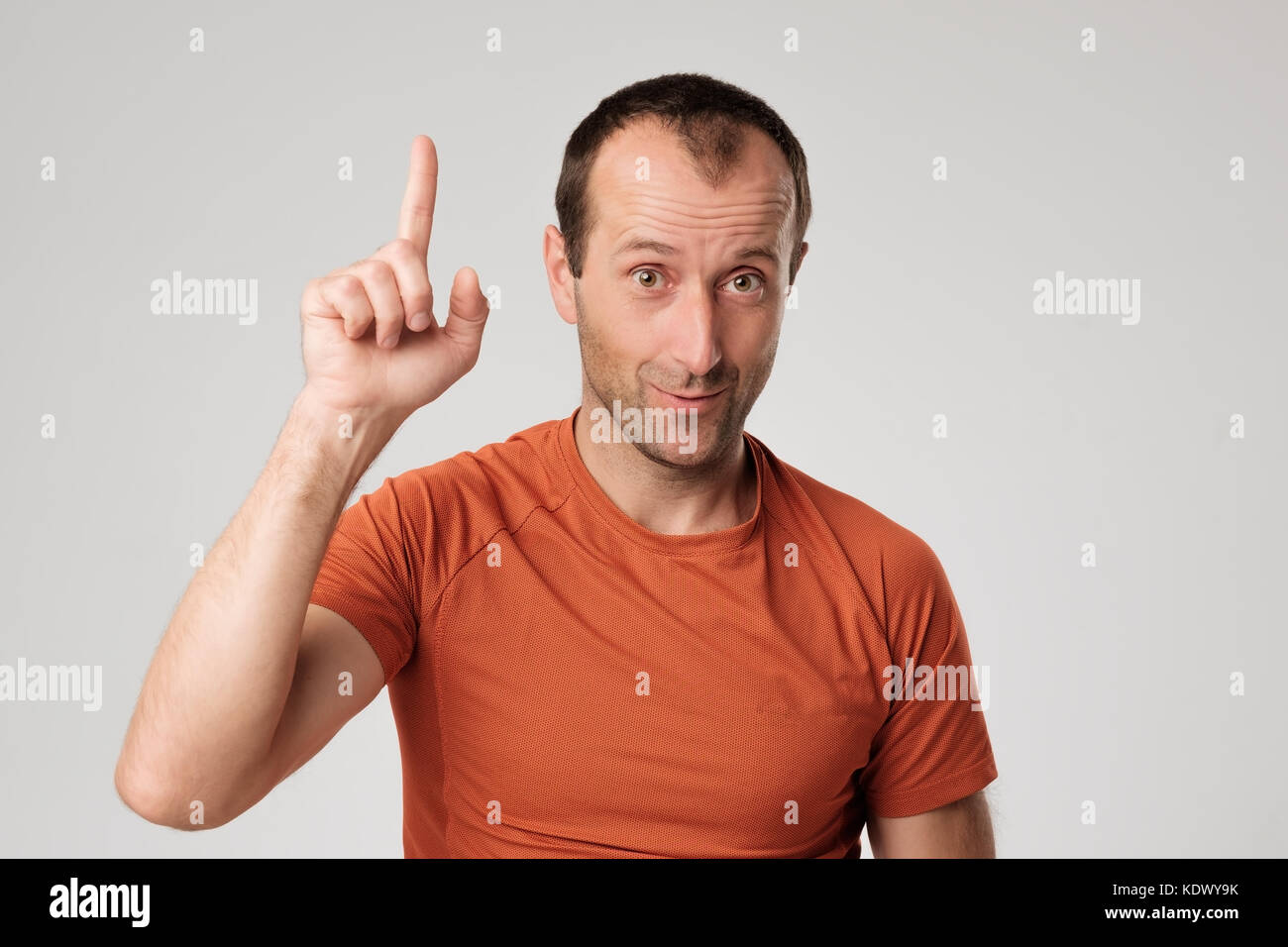 Mature hispanic man showing upwards index finger. Stock Photo
