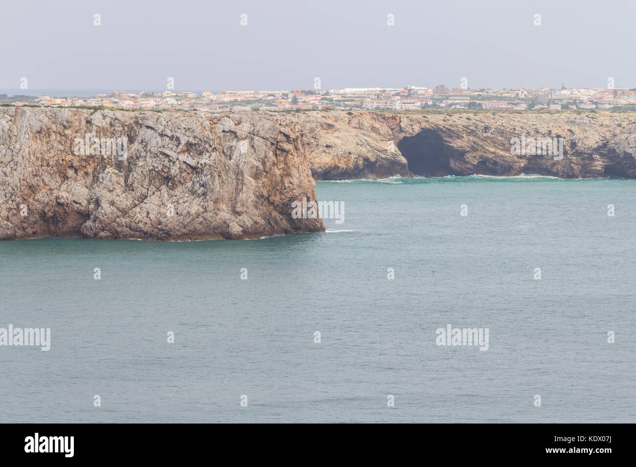 Cliffs and Sagre village  in Cabo de Sao Vicente, Sagres, Algarve, Portugal Stock Photo