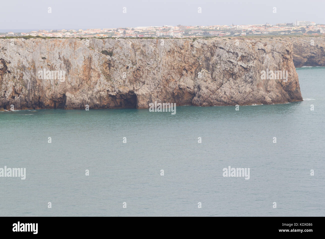 Cliffs and Sagre village  in Cabo de Sao Vicente, Sagres, Algarve, Portugal Stock Photo