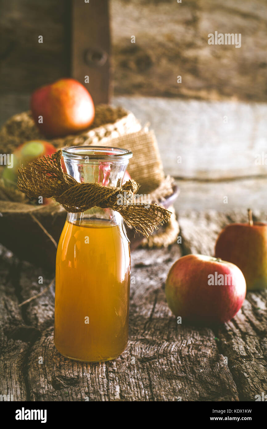 Apple vinegar. Bottle of apple organic vinegar on wooden background