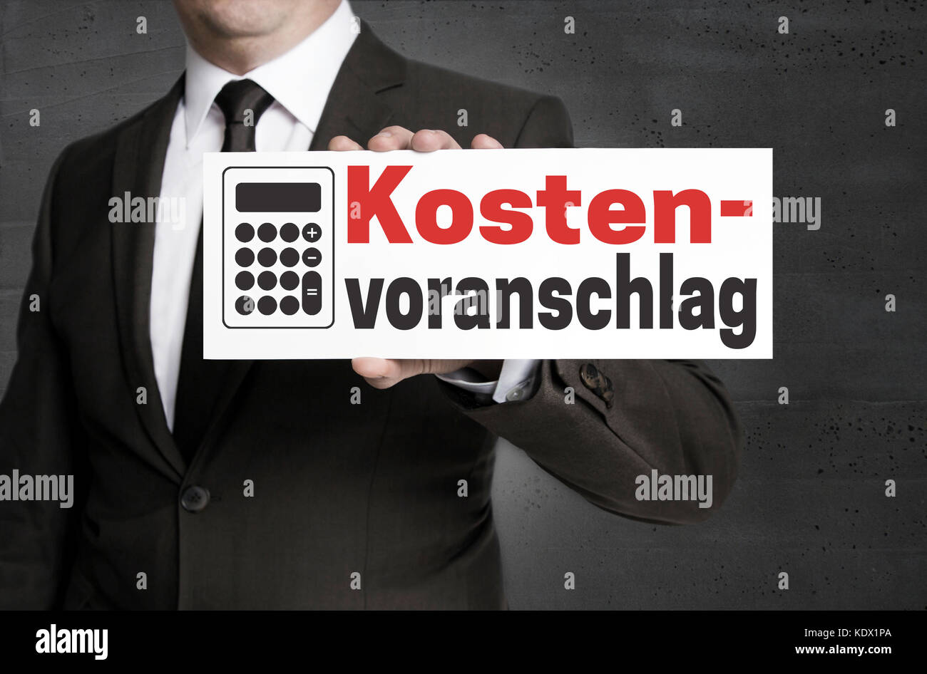 Kostenvoranschlag (in german Cost estimate) signboard is held by businessman. Stock Photo