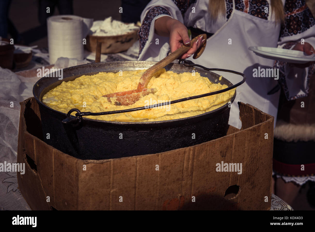 Traditional Romanian food, hominy (mamaliga) prepared in a caldron on fire Stock Photo