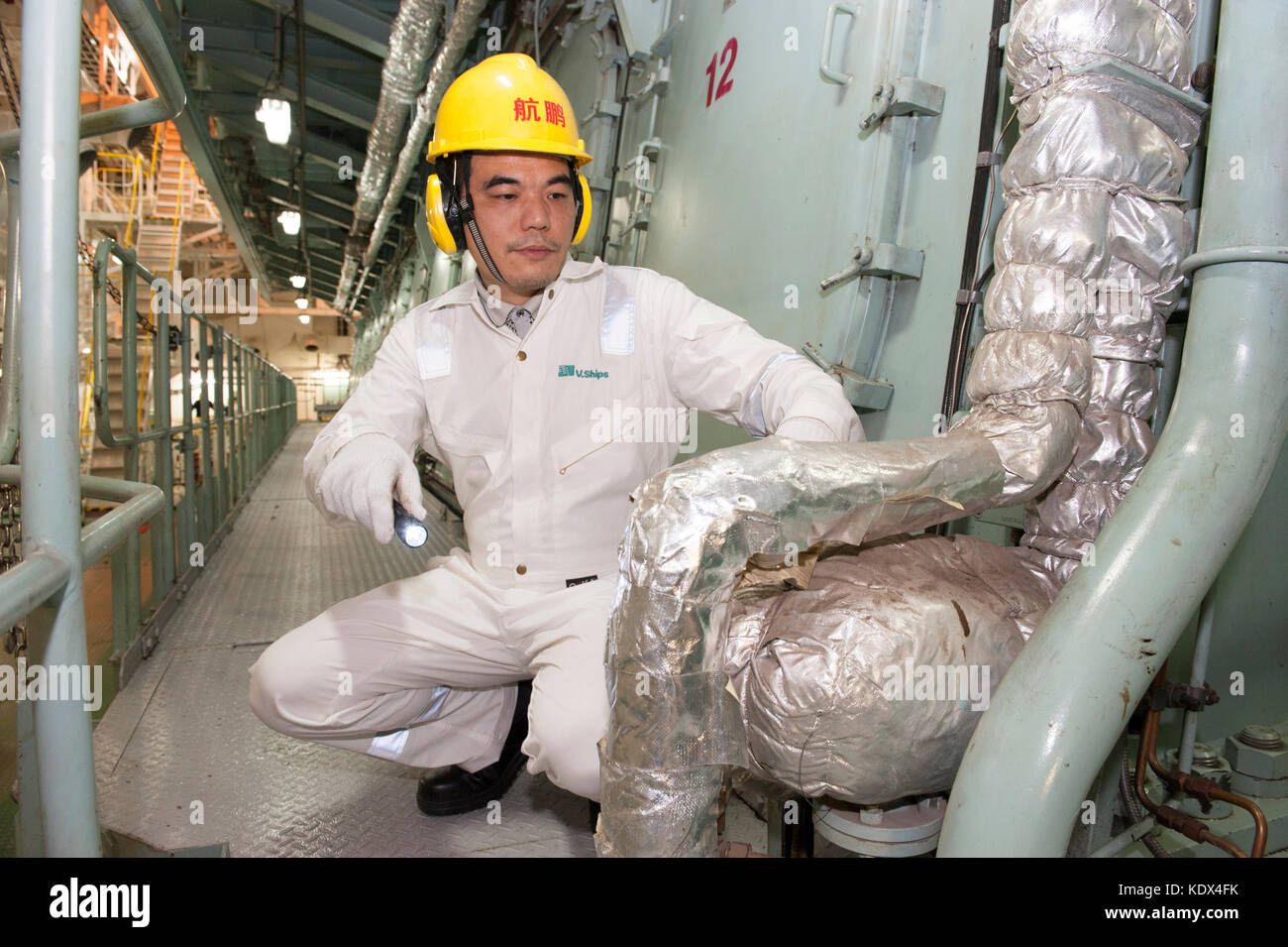 Marine engineer in ship's engine room Stock Photo Alamy