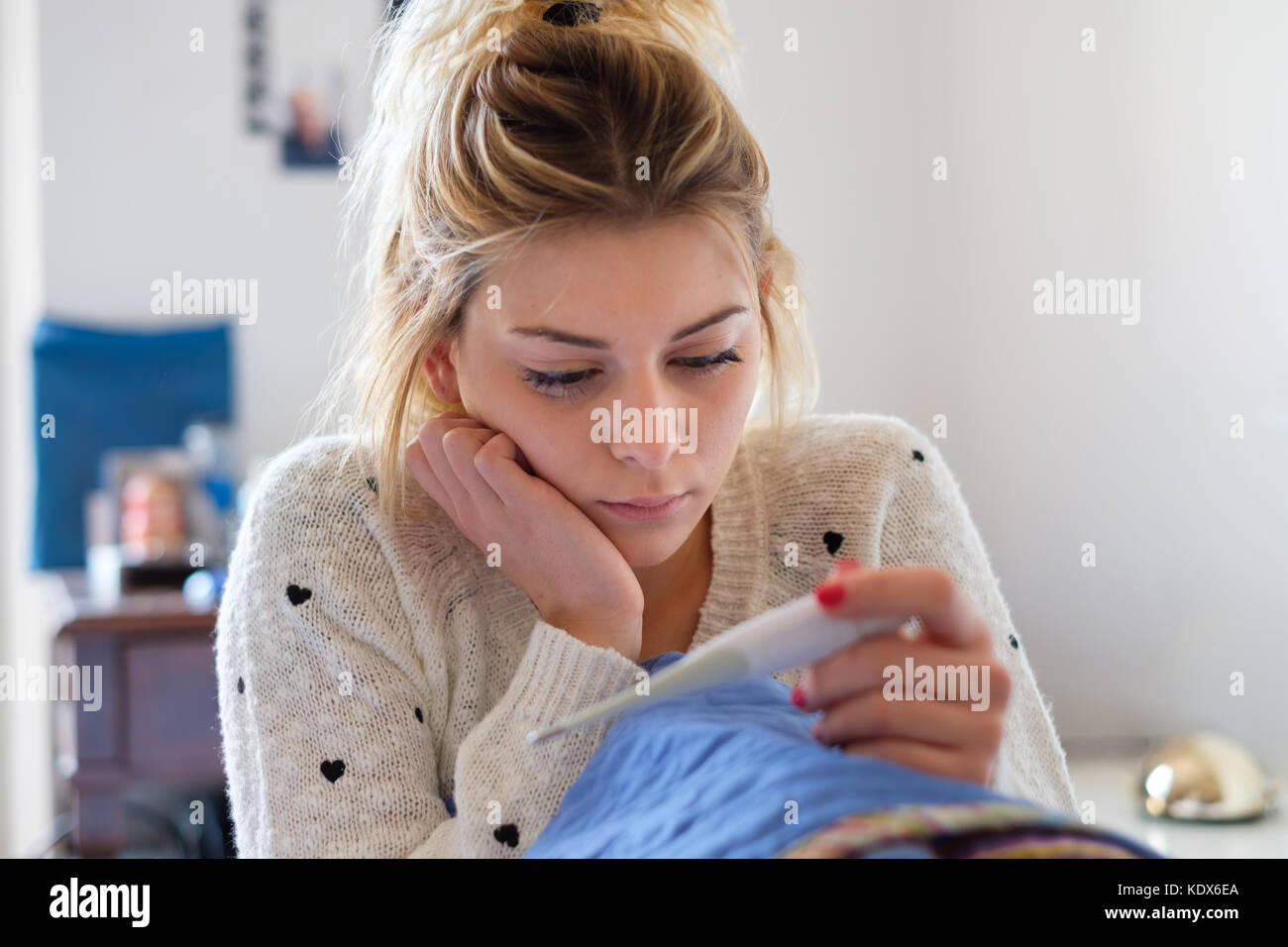 Sad young girl reading a pregnancy test result Stock Photo