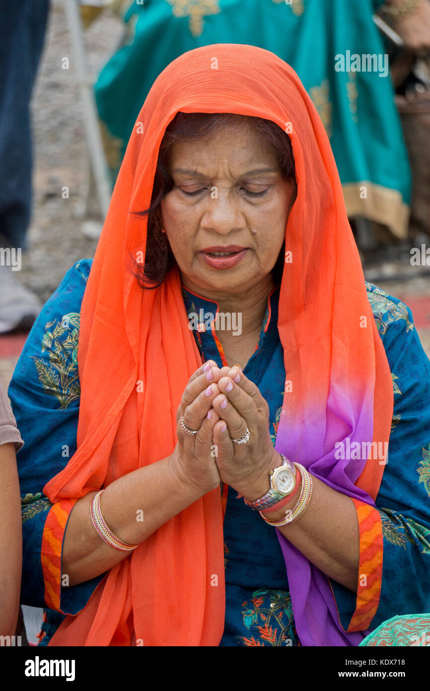 Portrait of a Guyanese Hindu woman in solemn prayer at the Lakshmi Hawan services at the Diwali Motorcade in Richmond Hill, Queens, New York. Stock Photo