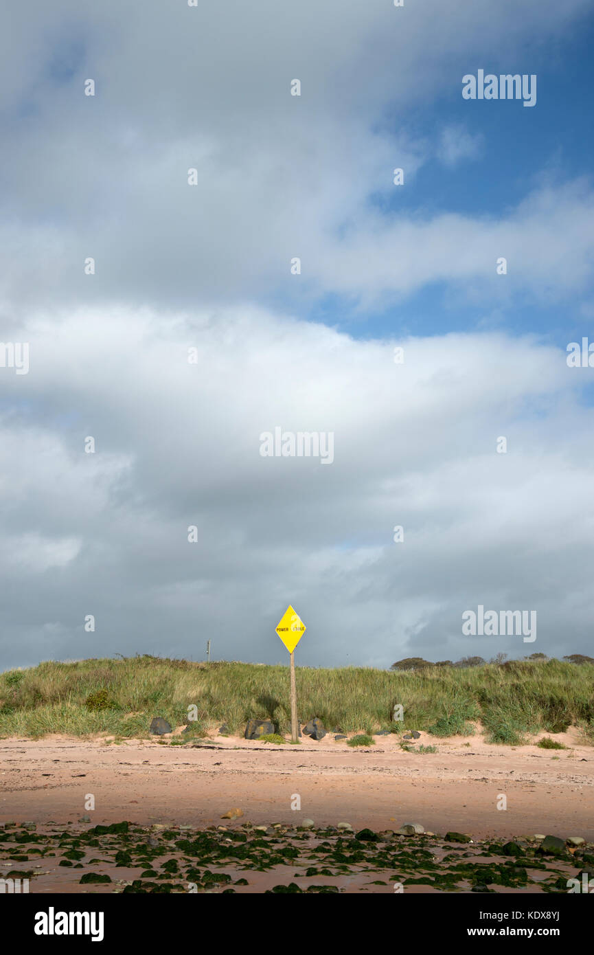Scotland September 2017. West Kilbride beach with power cable sign Stock Photo