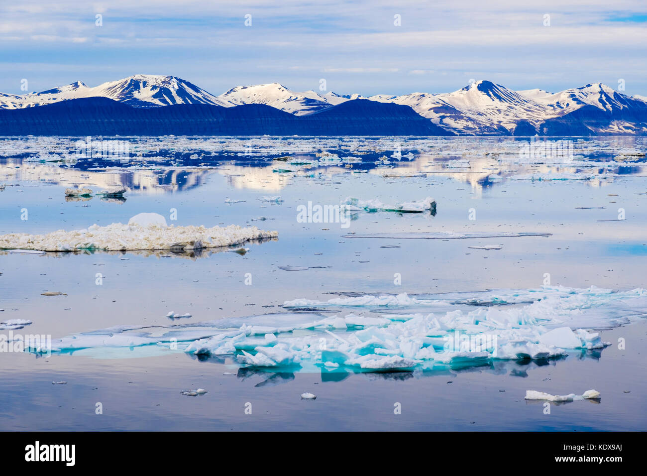 Offshore view across Storfjorden sea ice floe to mountains on east coast at 2 am in arctic summer. Spitsbergen island, Svalbard, Norway, Scandinavia Stock Photo