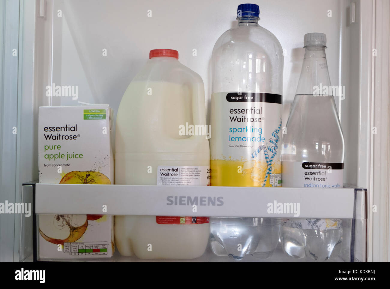 Essential Waitrose drink products in a fridge Stock Photo