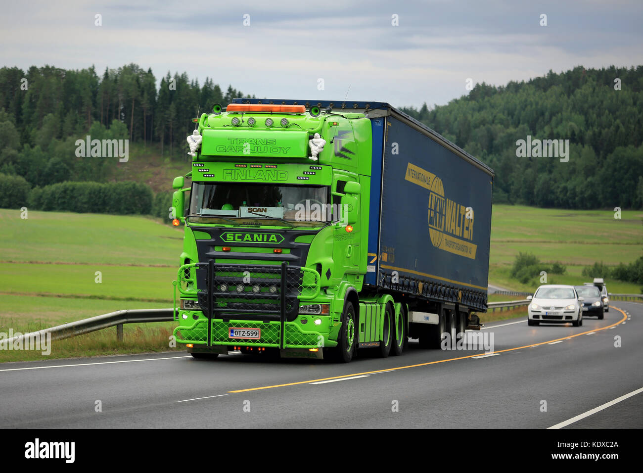 SALO, FINLAND - JUNE 26, 2016: Lime green Scania R series Semi trailer show truck moves uphill along road in South of Finland at Summer. Stock Photo