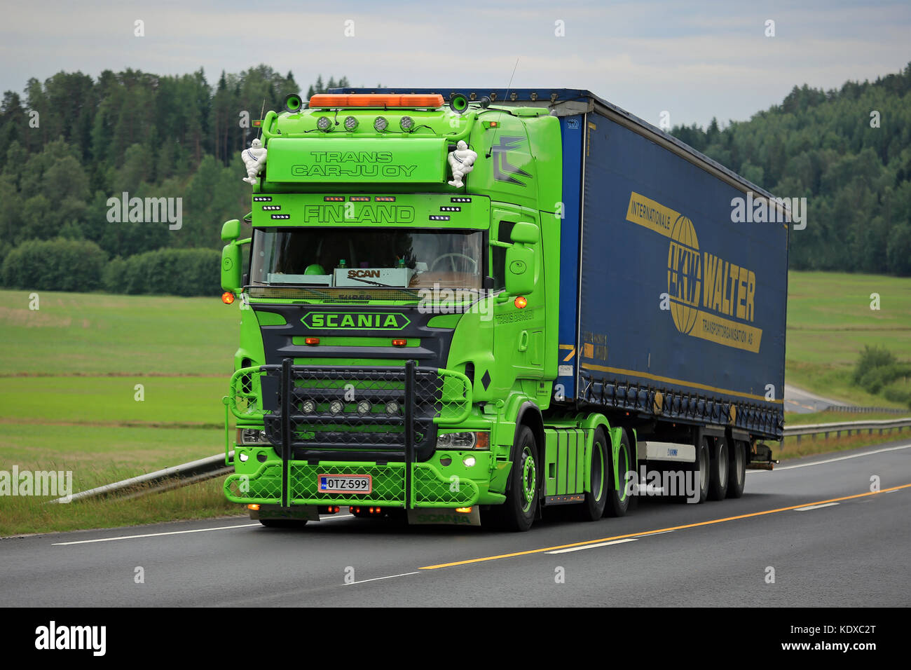 SALO, FINLAND - JUNE 26, 2016: Lime green Scania R series Semi trailer show truck moves uphill along road in South of Finland at Summer. Stock Photo