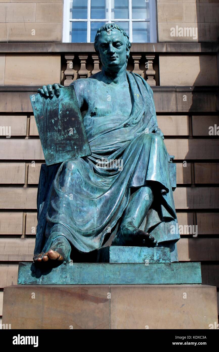 Philosopher David Hume‘s statue sits pondering outside the High Court on the Royal Mile.The big toe is a touchstone for those hoping to gain knowledge. Stock Photo