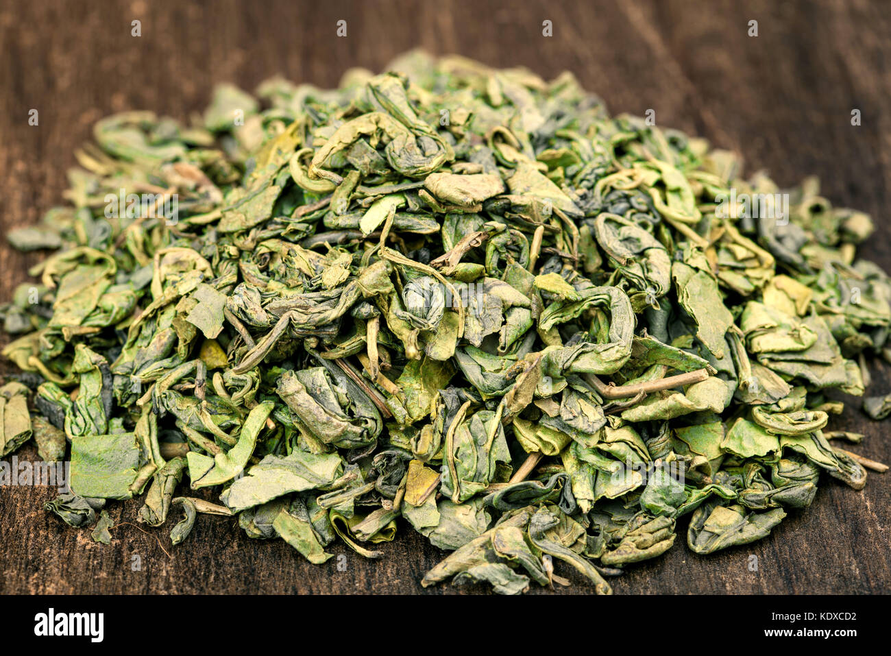 Green or black tea leaves on wooden plate or background Stock Photo Alamy