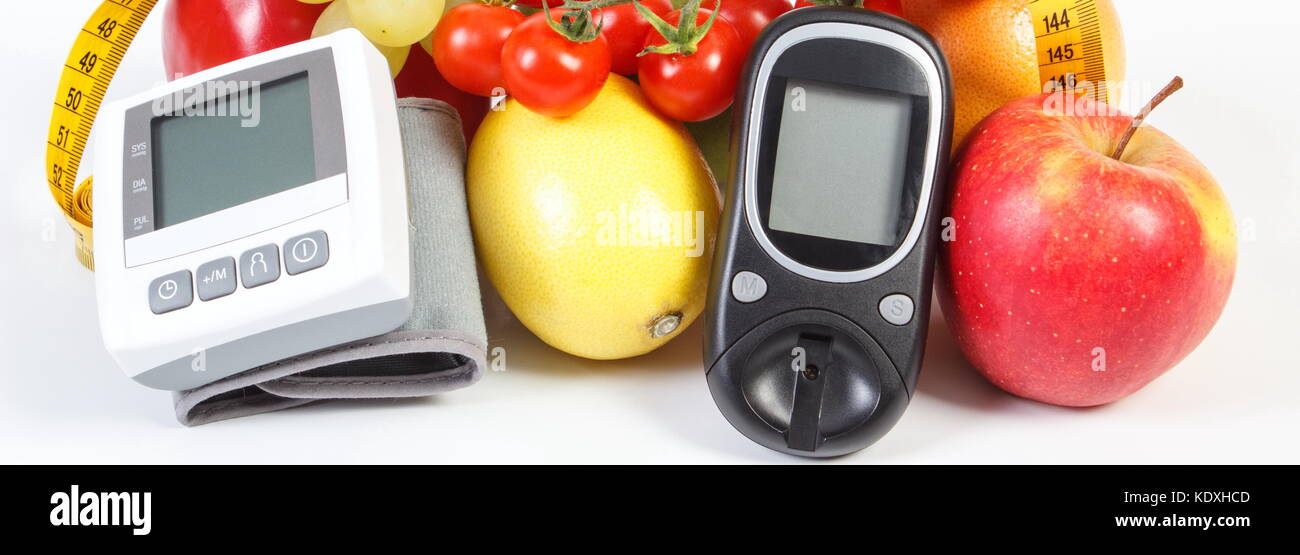 Glucose meter for checking sugar level, blood pressure monitor, fresh  fruits with vegetables and tape measure, slimming, diabetes and prevention  of hy Stock Photo - Alamy