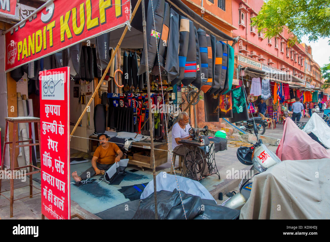 Jaipur, India - September 19, 2017: Unidentified man confectioning motobike seat covers at Johari Bazaar street on November 15, 2014 in Jaipur, India. Jaipur is the capital and the largest city of Rajasthan Stock Photo