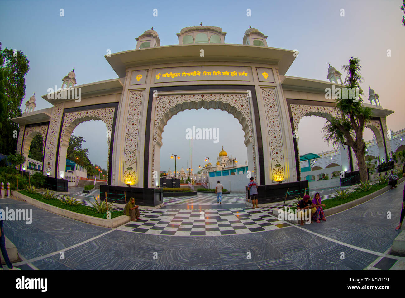 DELHI, INDIA - SEPTEMBER 19, 2017: Big white gate to the enter of Gurudwara Bangla Sahib Sikh Temple, located in New Delhi, India, fish eye effect Stock Photo