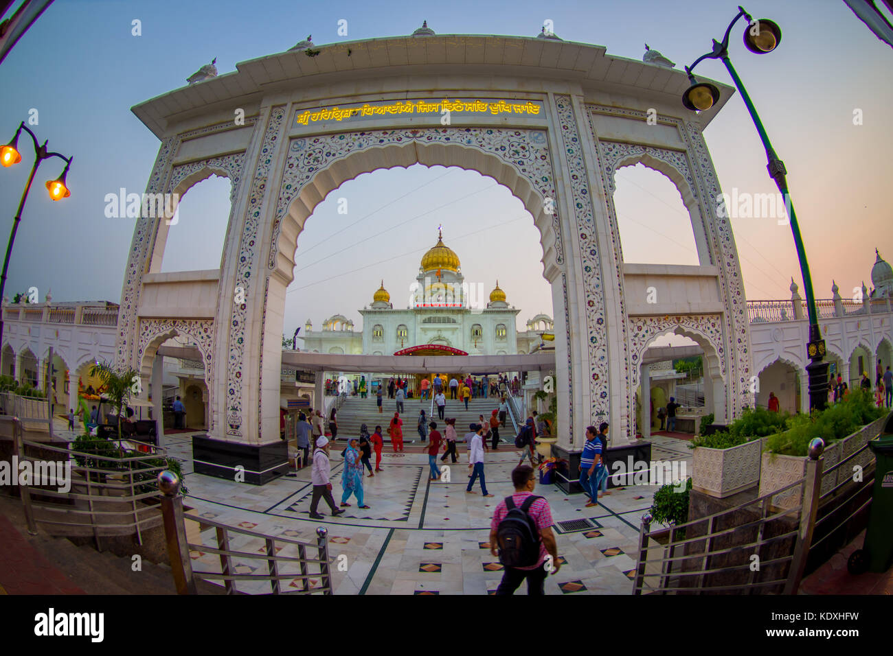 DELHI, INDIA - SEPTEMBER 19, 2017: Unidentified people at the enter in the arch of Gurudwara Bangla Sahib Sikh Temple, in New Delhi, India, fish eye effect Stock Photo