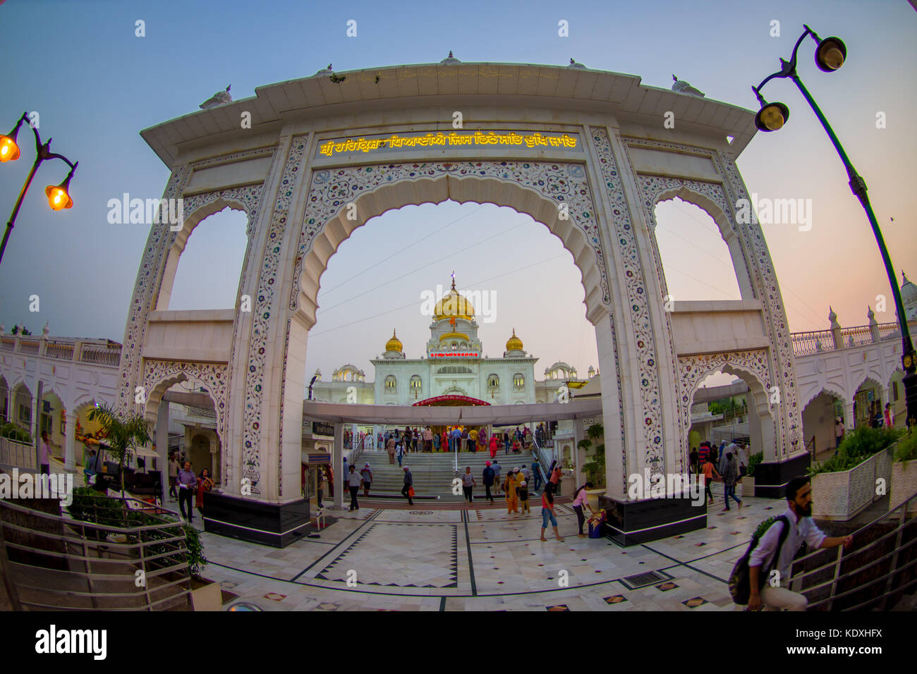 DELHI, INDIA - SEPTEMBER 19, 2017: Unidentified people at the enter of Gurudwara Bangla Sahib Sikh Temple, in New Delhi, India, fish eye effect Stock Photo