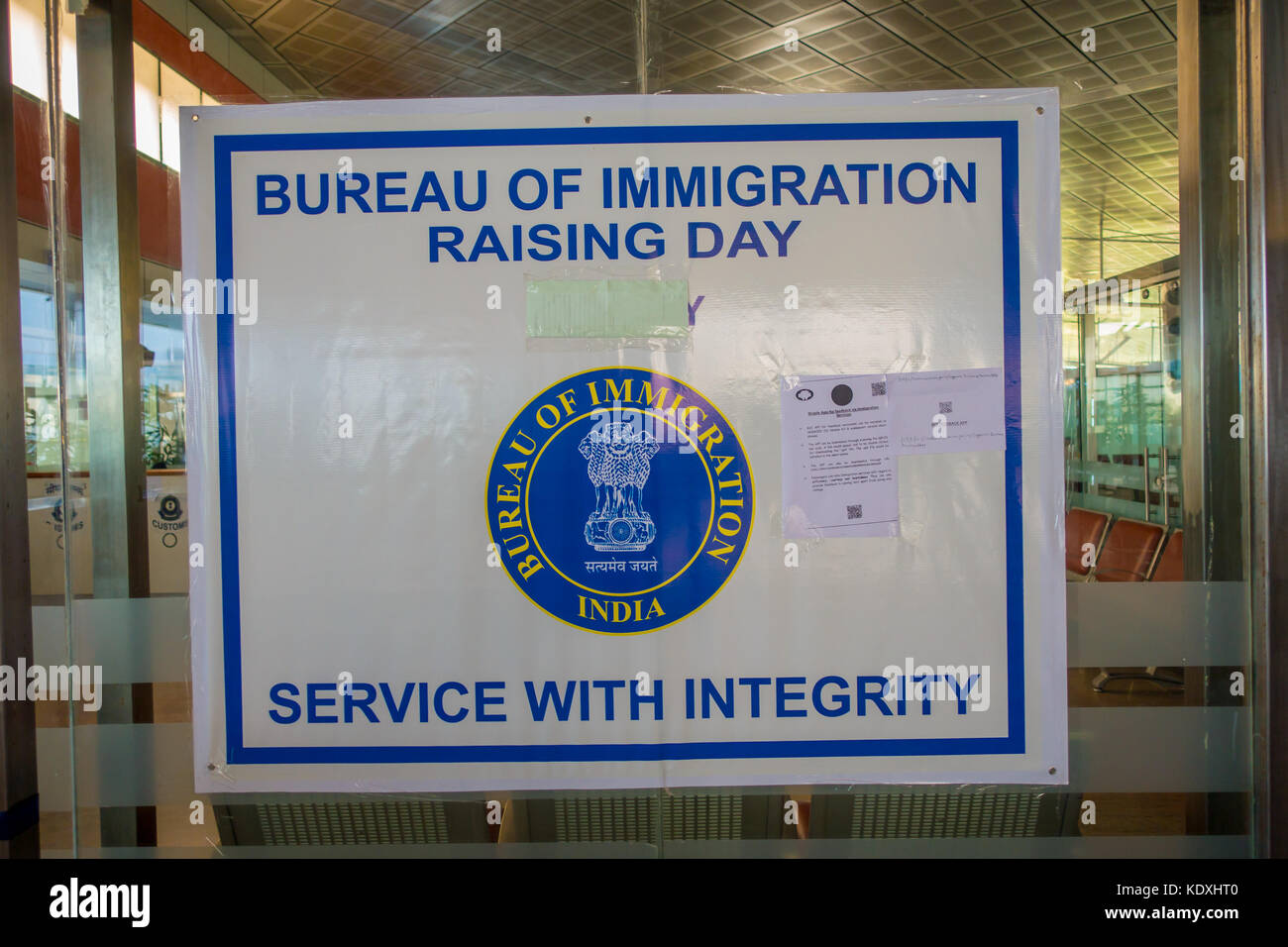 DELHI, INDIA - SEPTEMBER 19, 2017: Informative sign in the exit of the International Airport of Delhi and crowd, Indira Gandhi International Airport is the 32th busiest in the world Stock Photo