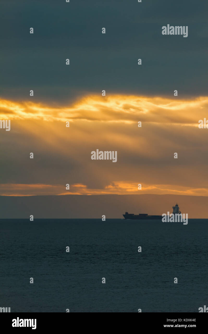 Container Cargo ship in the ocean at sunset sky, silhouette Stock Photo ...
