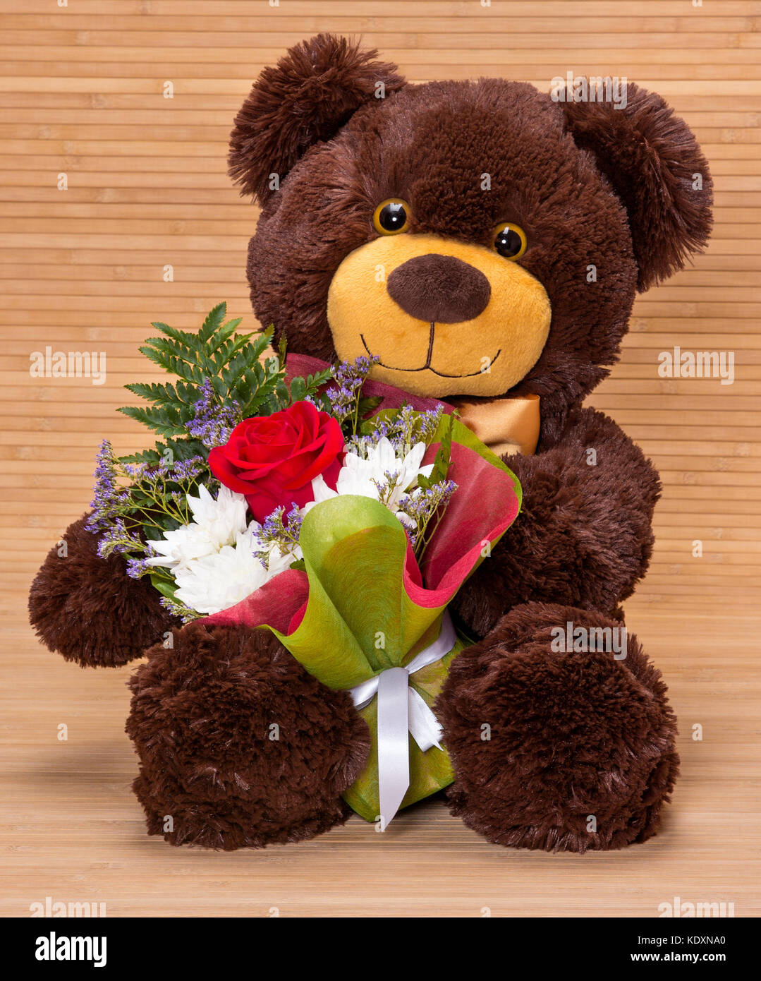 Smiling teddy bear holding beautiful floral bouquet in paws Stock ...