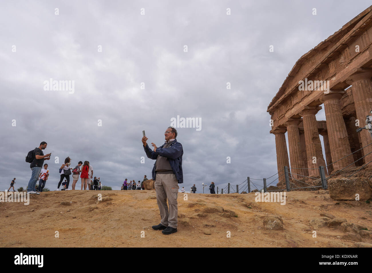 A tourist taking a selfie at the Greek archeological site of Agrigento in the so-called valley of the Temples. From a series of travel photos in Sicil Stock Photo