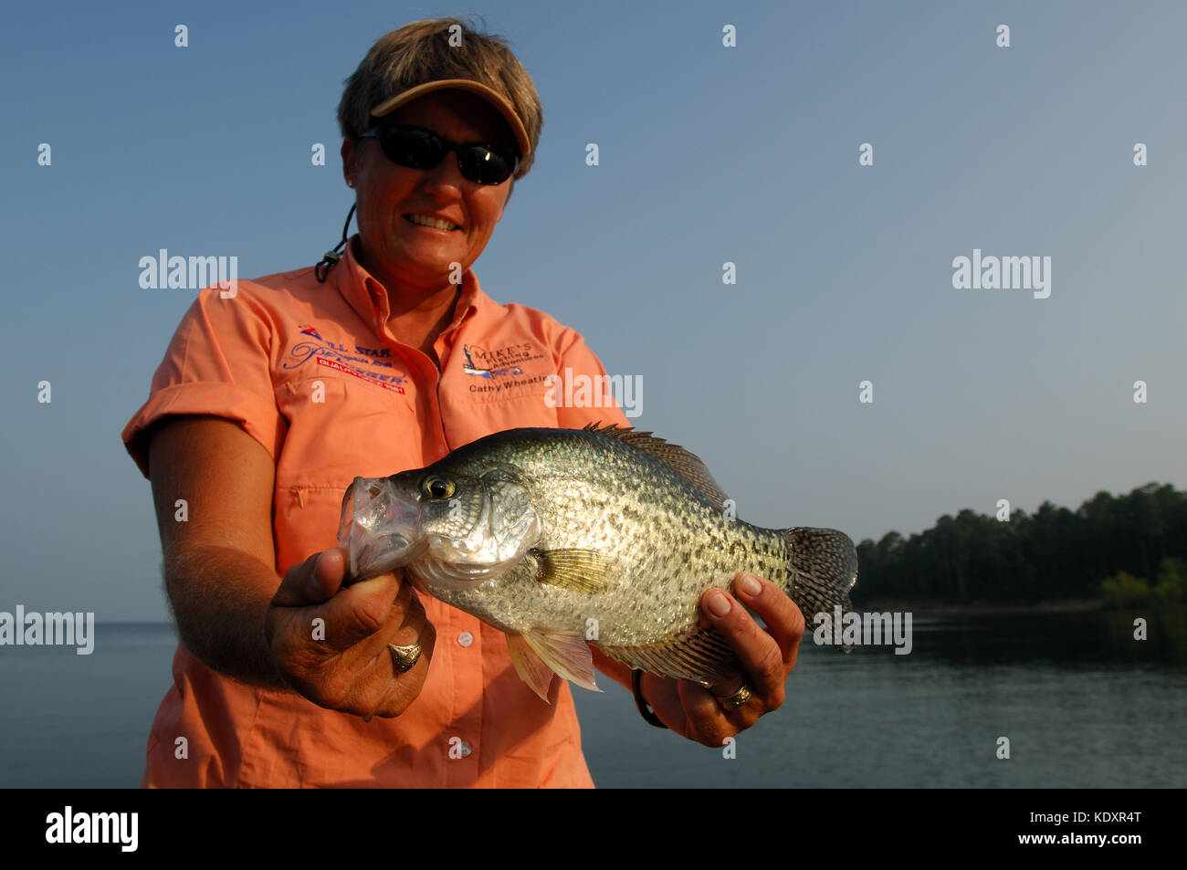 An angler holds a crappie fish caught on Lake Sam Rayburn near Jasper Texas Stock Photo