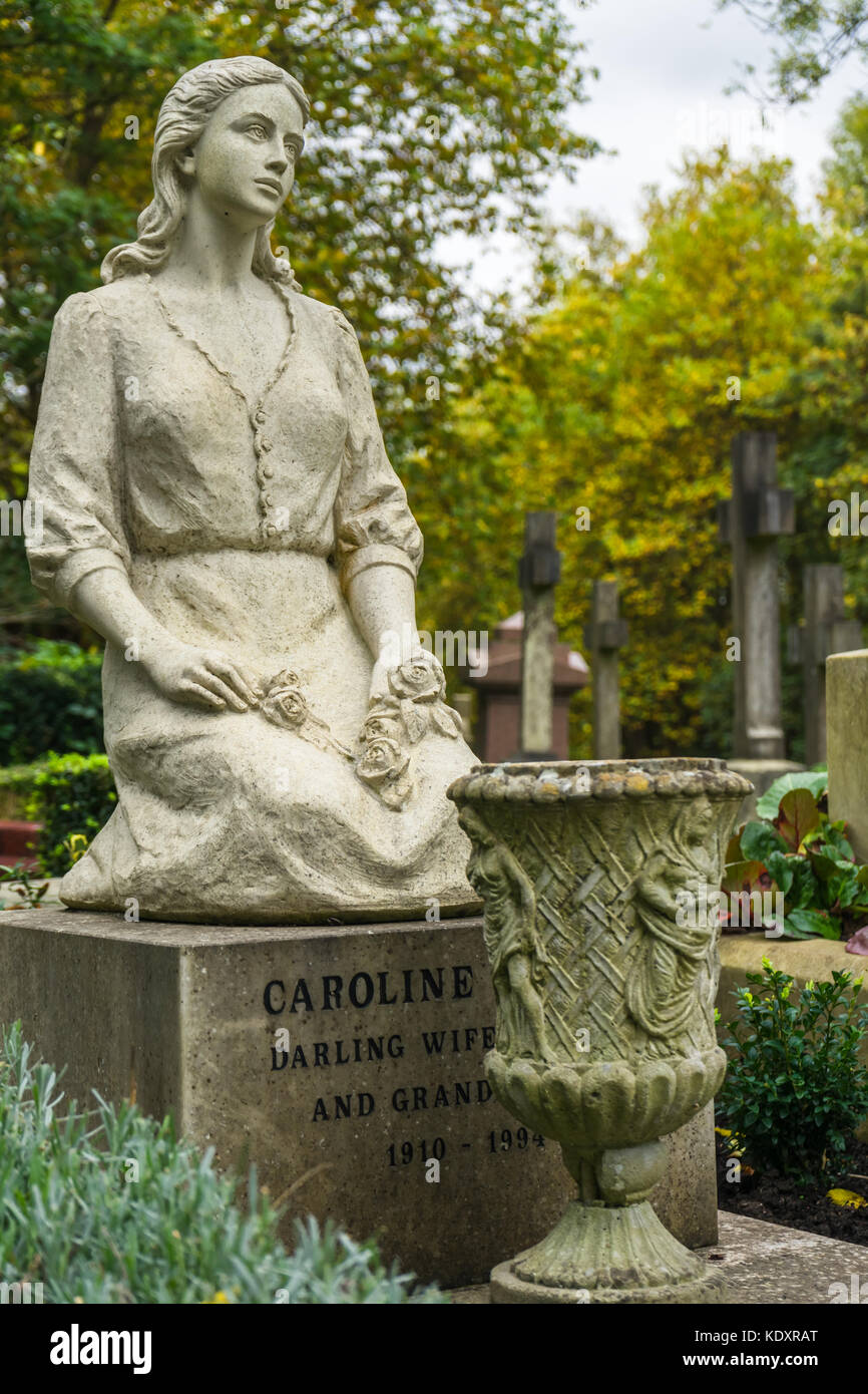 Unusual tombstone statue in the shape of a young woman at Highgate