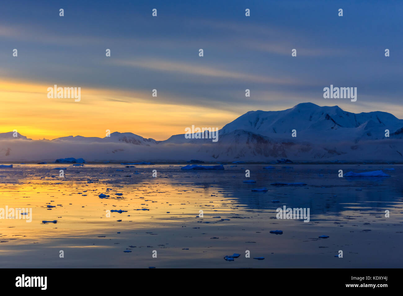 Sunset over idyllic lagoon with mountains and icebergs in the ...