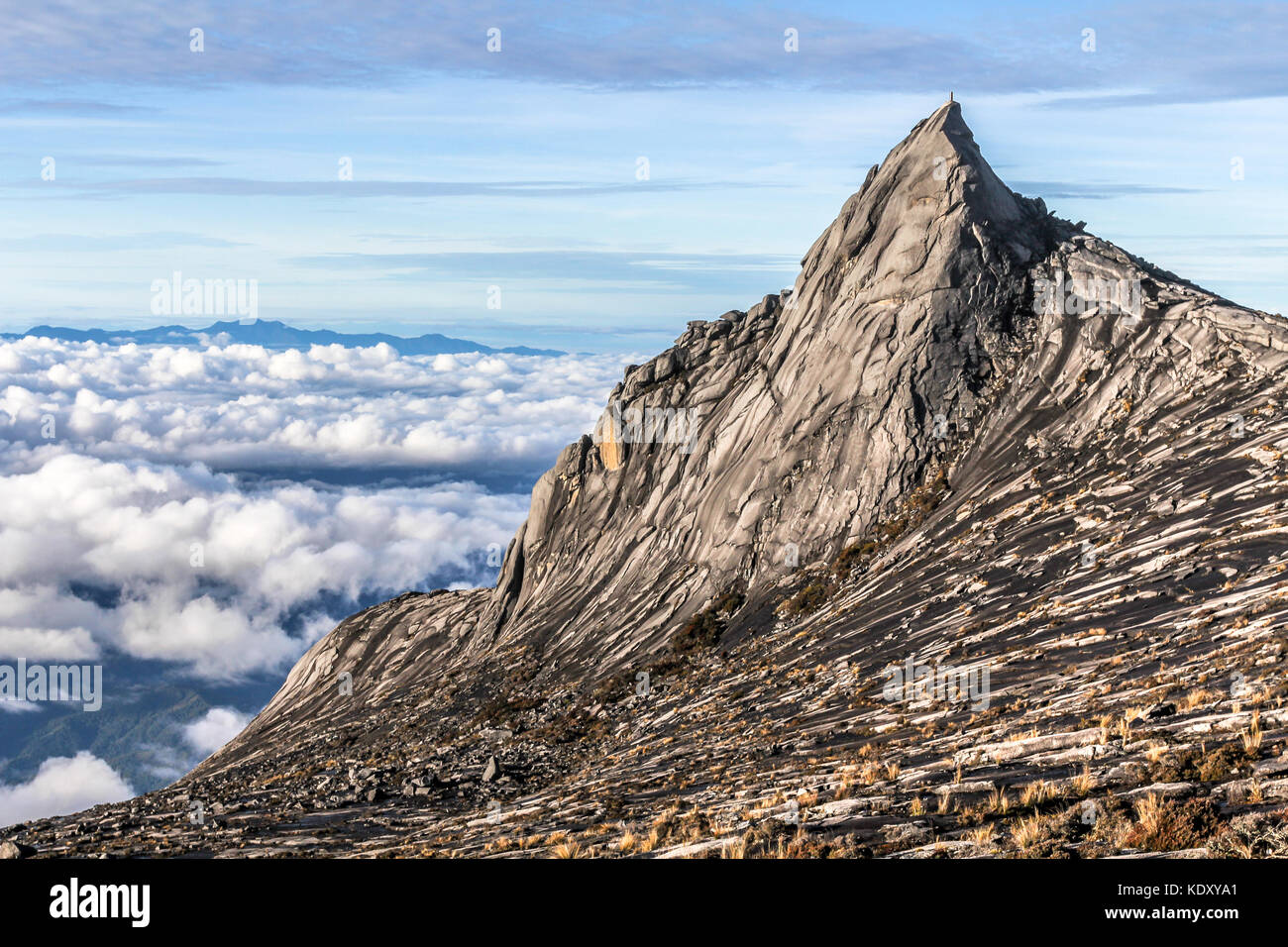 Peak of Mount Kinabalu and clouds below in the morning hours, Kota Kinabalu national park Borneo, Malaysia Stock Photo