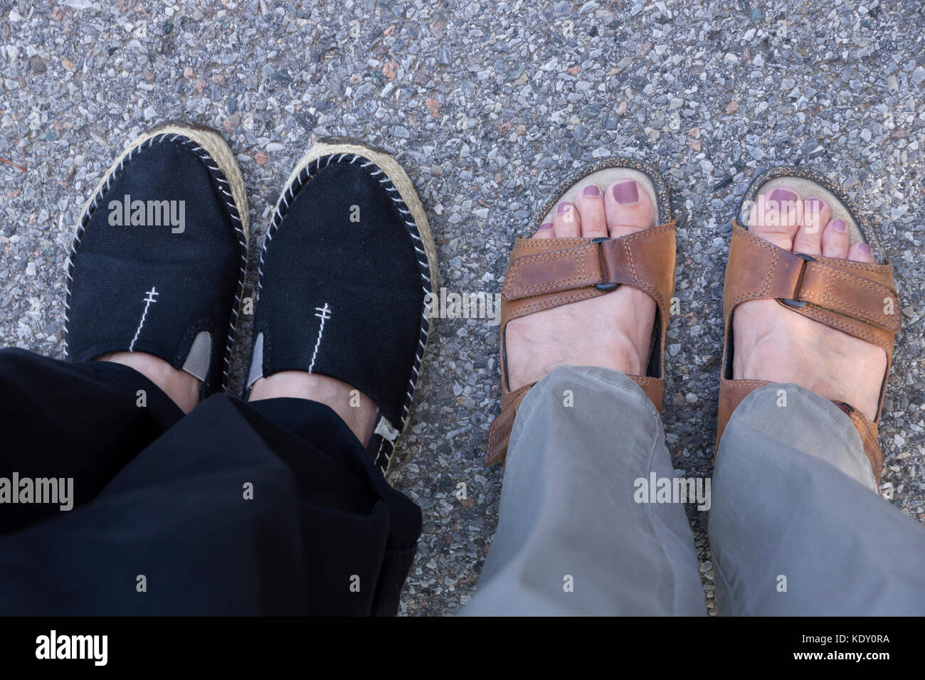 Casual summer footwear choices:  women's closed-toe shoes (espadrilles) and open-toe sandals. Stock Photo