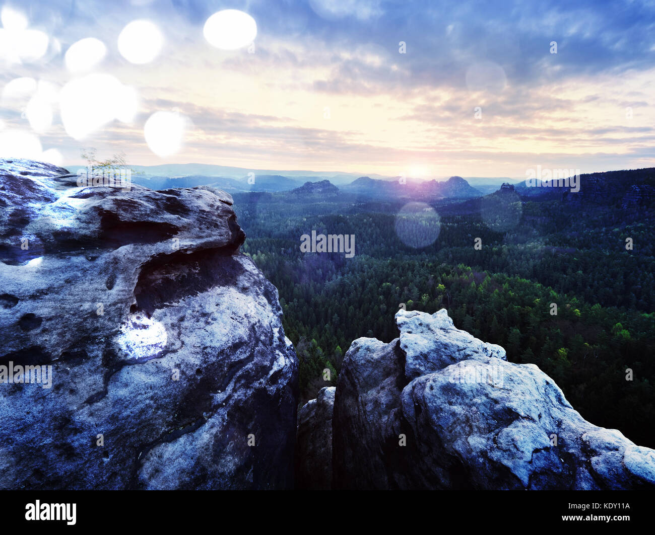 Lens defect. Spring morning nature. The cracked sandstone cliff above ...