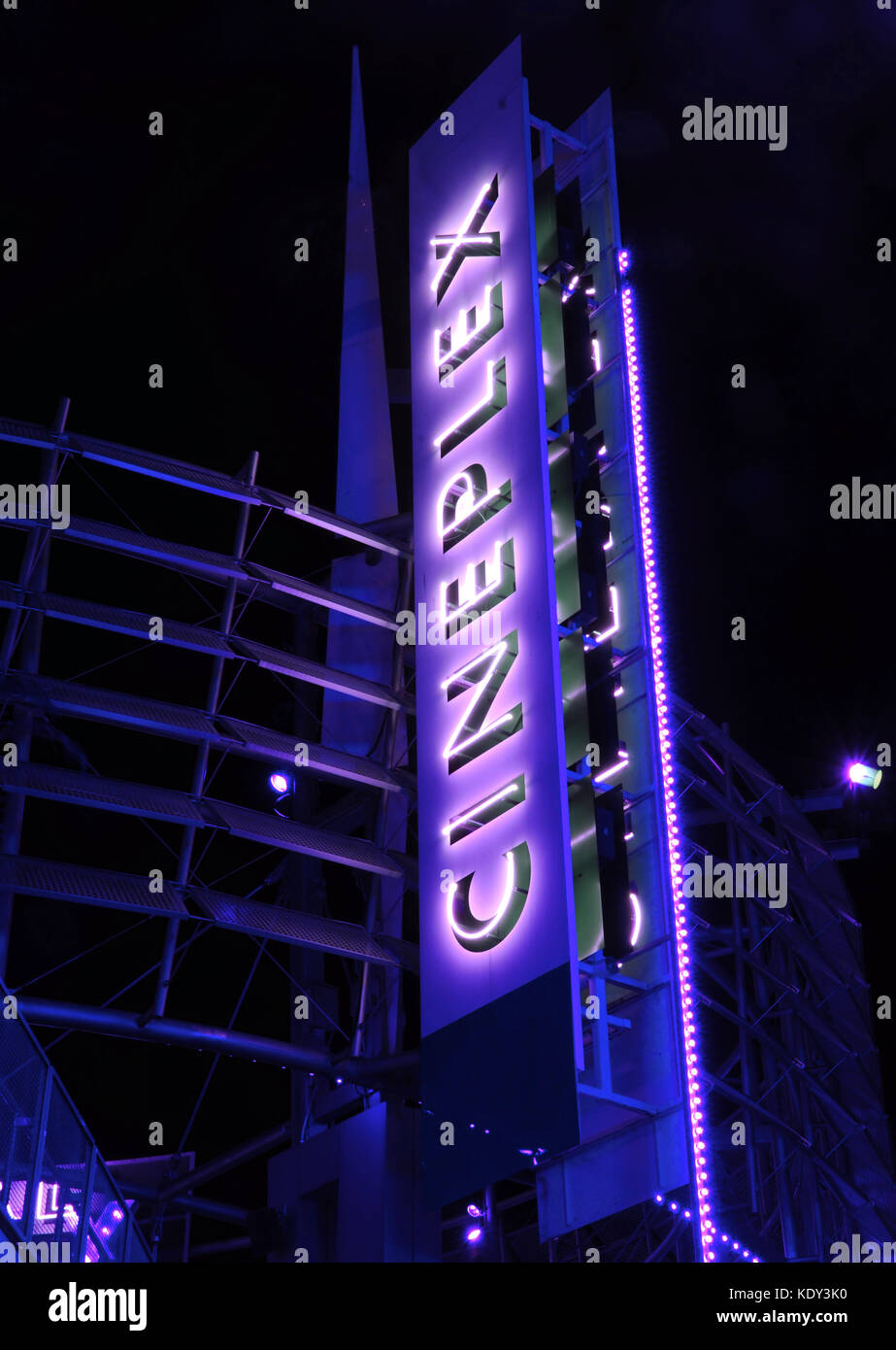 Giant vertical neon sign advetising movie theater Stock Photo