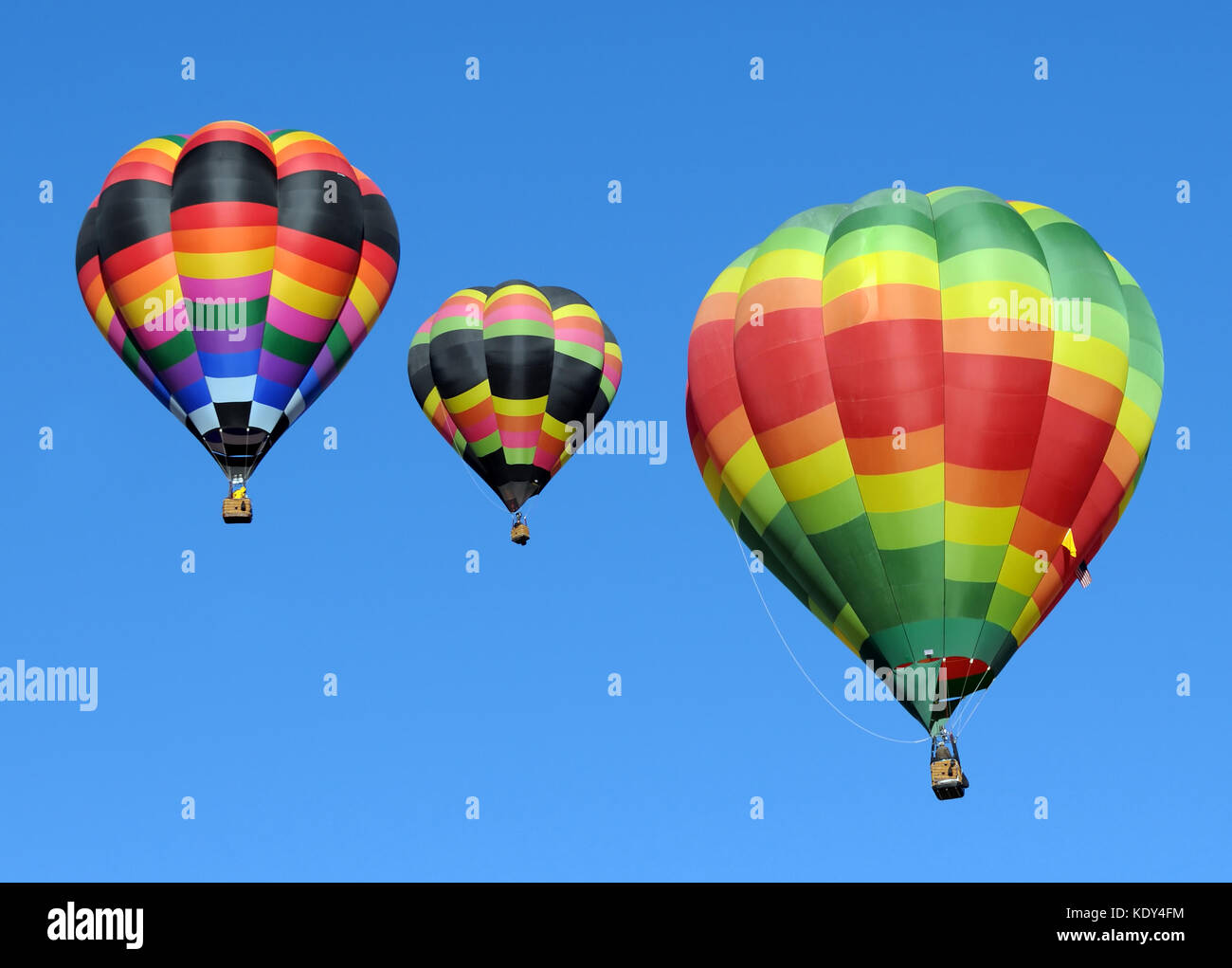 Three colorful hot air balloons against blue sky Stock Photo - Alamy