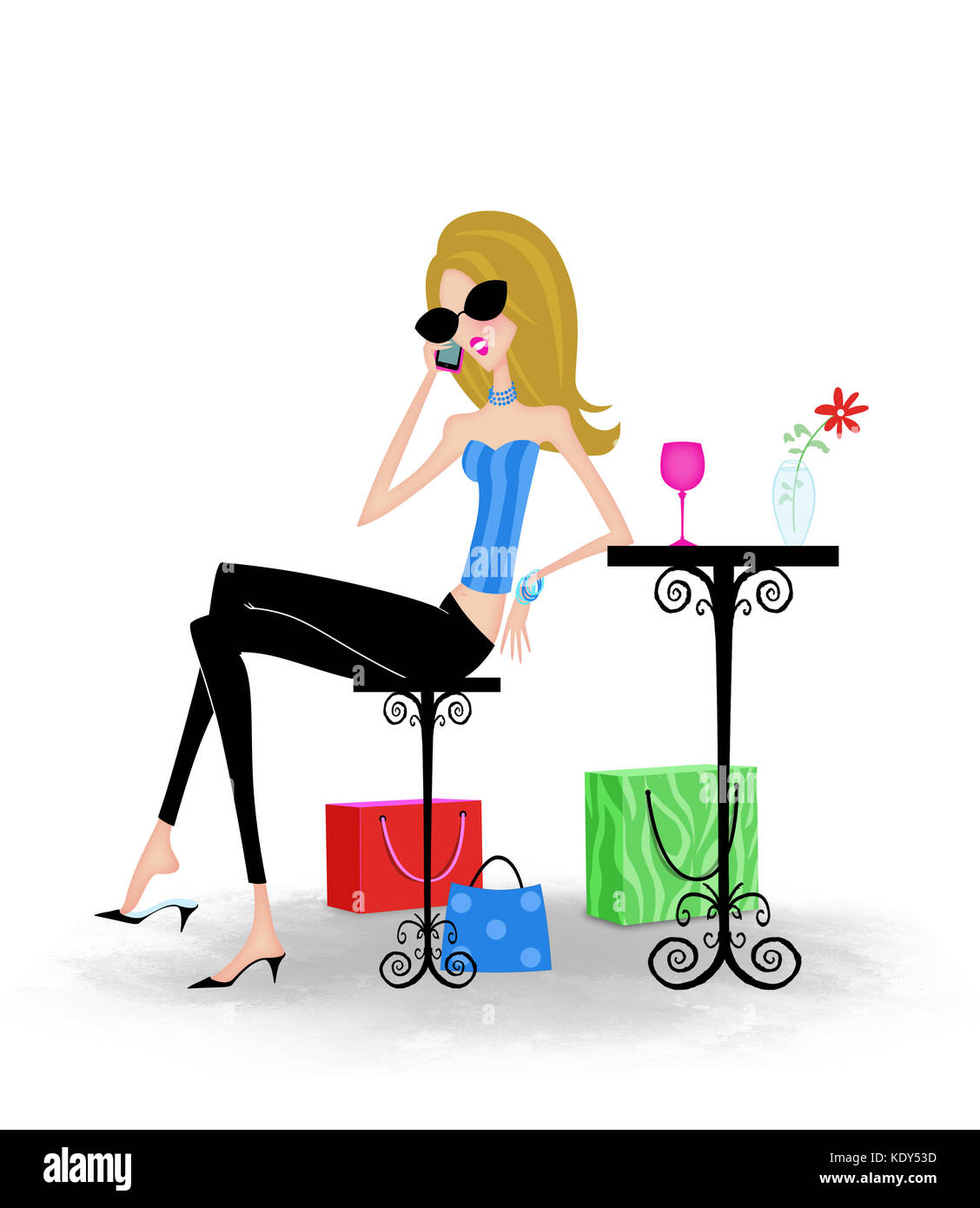Stylish trendy woman with shopping bags at an outdoor cafe talking on a cell phone Stock Photo