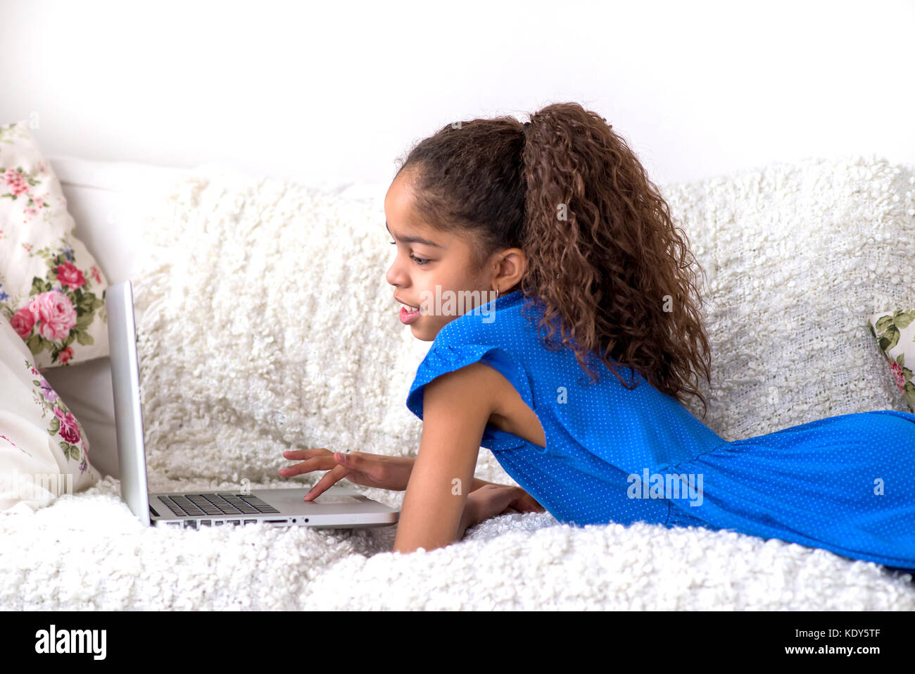 Teen girl laying on sofa hi-res stock photography and images - Alamy