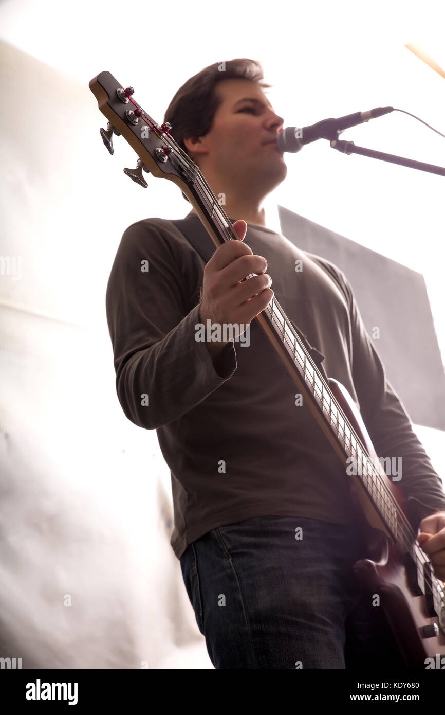 Black and white Portrait of a Rock singer playing bass in the rehearsal