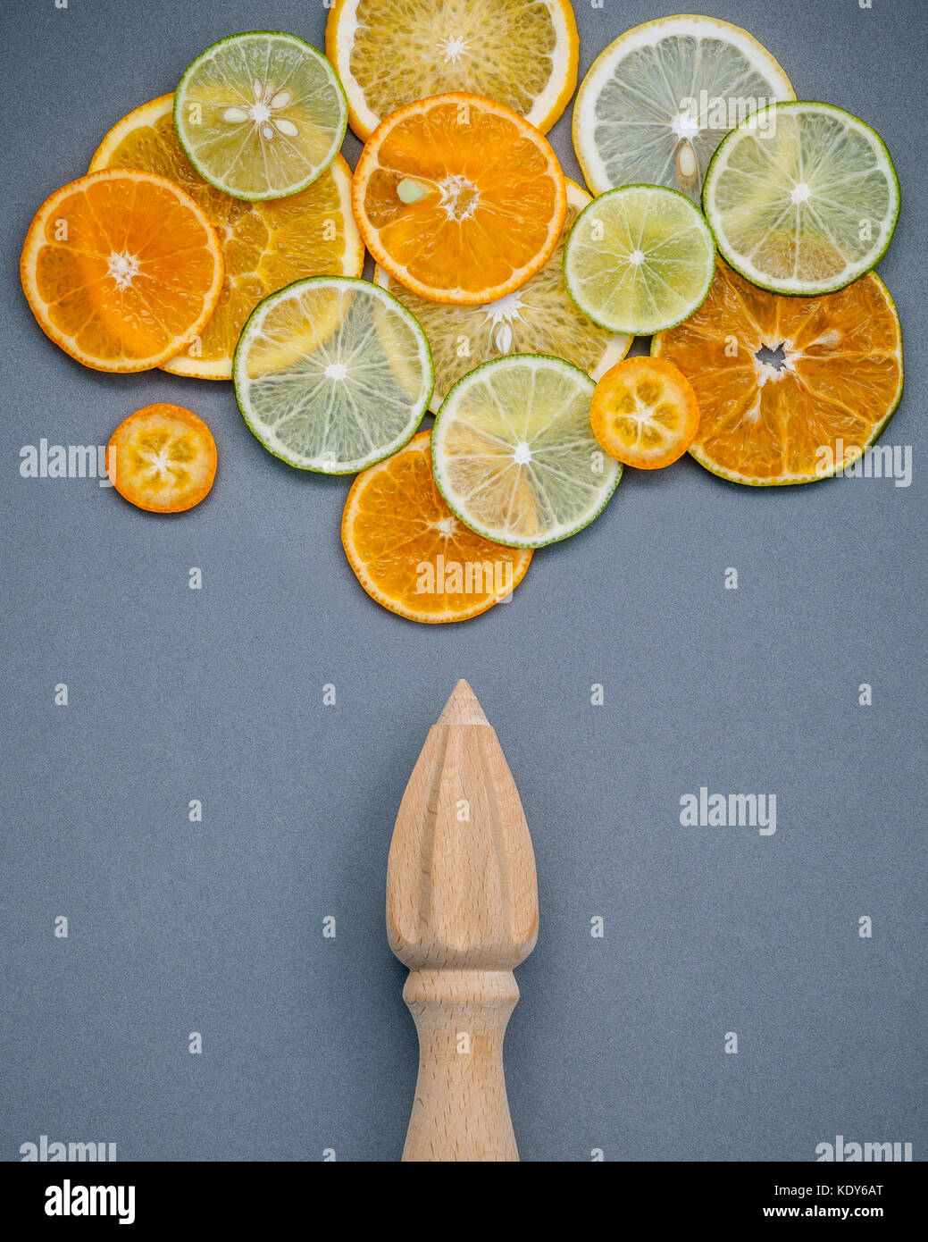Mixed fresh citrus fruits and wooden juicer for summer citrus juice