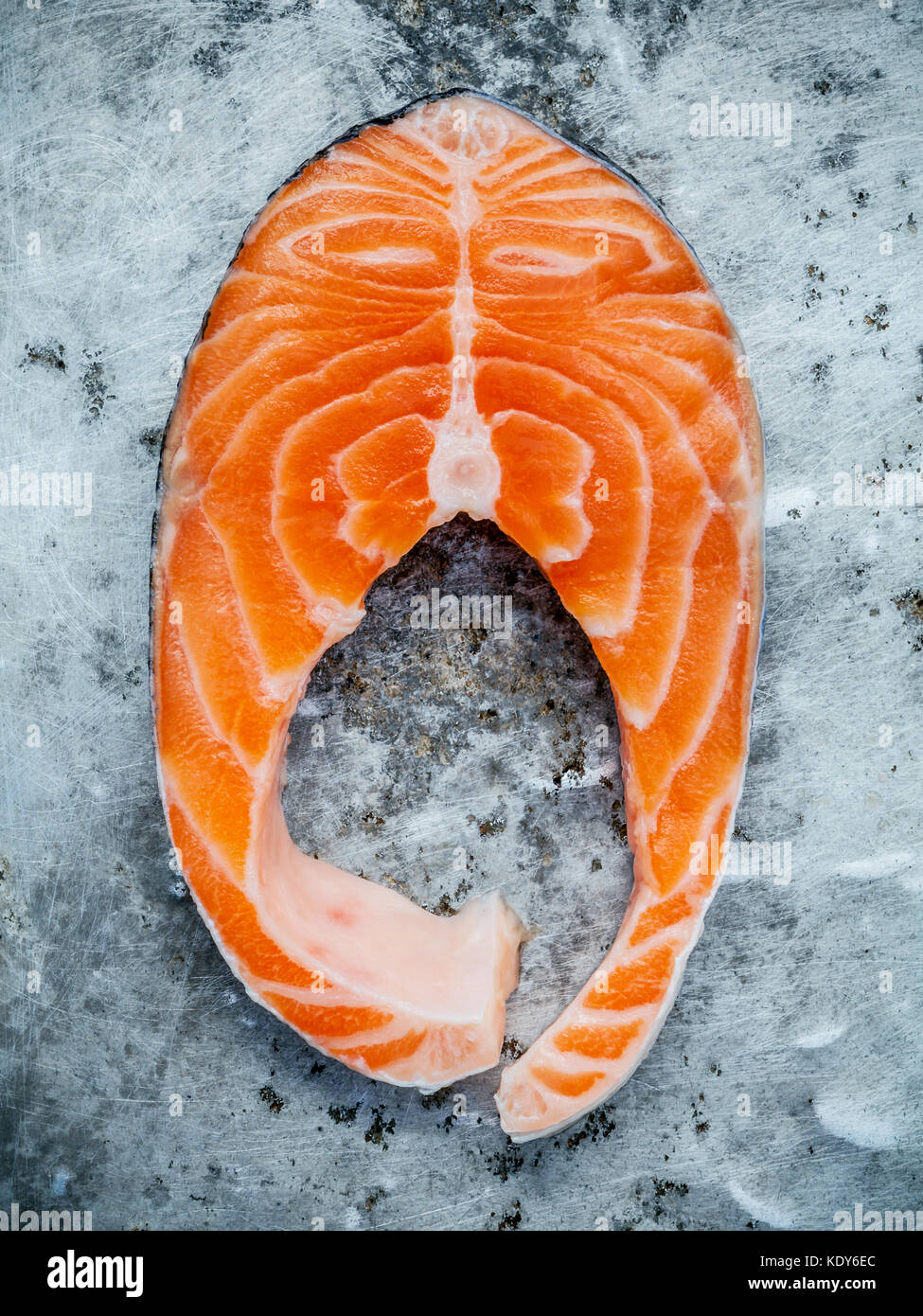 Closeup fresh salmon fillet sliced flat lay on shabby metal background ...
