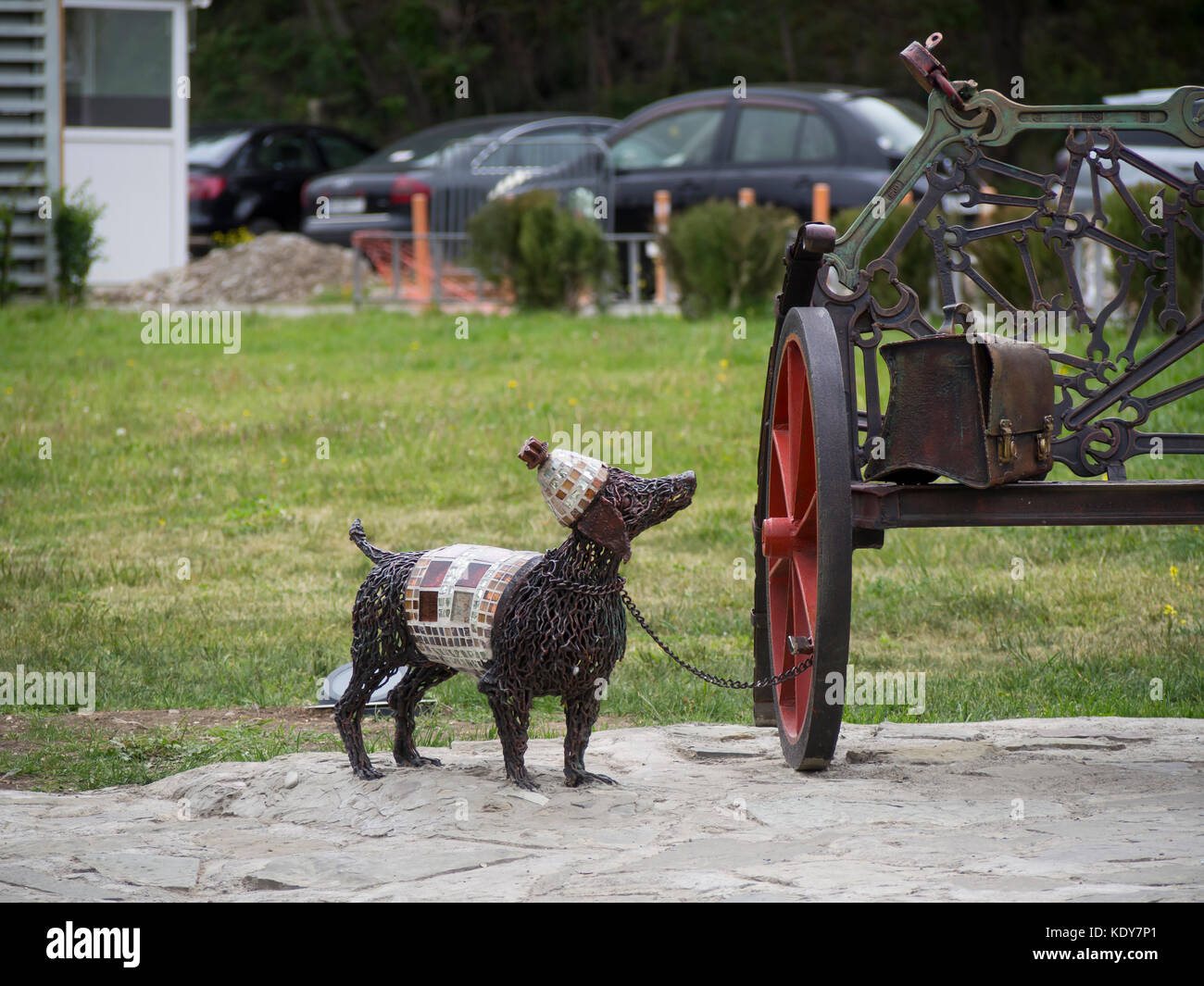 Recycling old metal tools into artwork, sculpture of poodle dog tied to a bench waiting for his master in the Rike park, Tbilisi Georgia Stock Photo