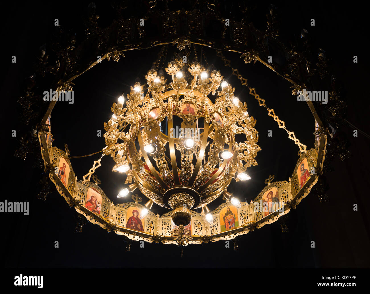 Magnificent gilded chandelier in the Virgin Mary Metekhi church in Tbilisi Georgia with images of saints Stock Photo