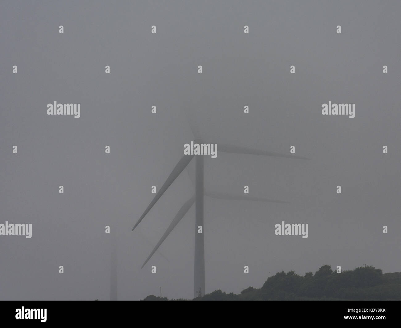 Wind turbines partly hidden by mist Stock Photo - Alamy