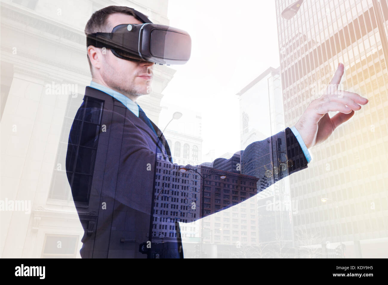 Handsome businessman pressing a button in VR Stock Photo