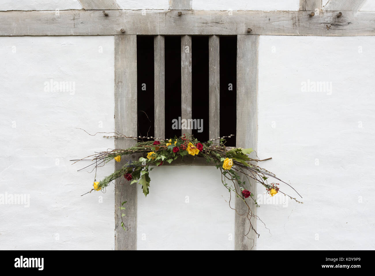 Autumn flower decoration on a medieval timber framed house window at Weald and Downland open air museum, autumn show, Singleton, Sussex, England Stock Photo