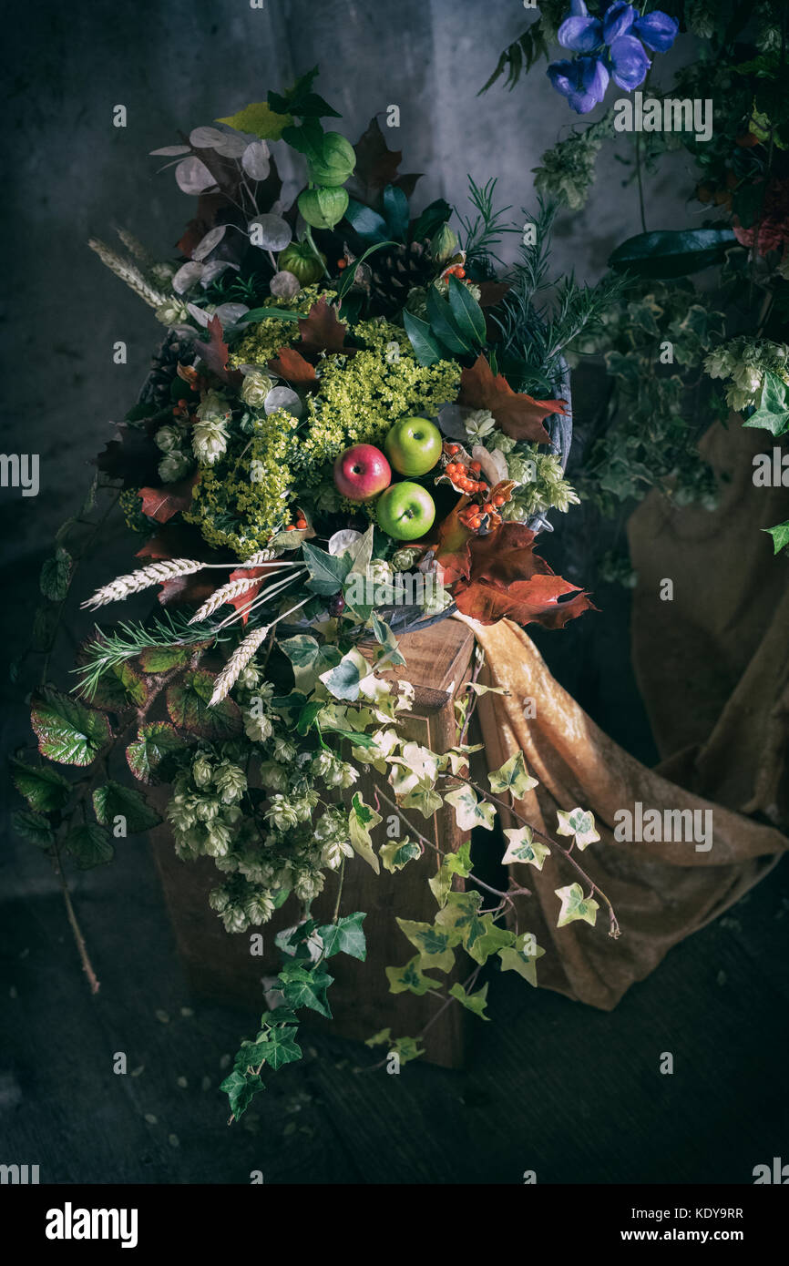 Autumn harvest display with apples, wheat and various foliage. UK. Applied vintage faded filter Stock Photo