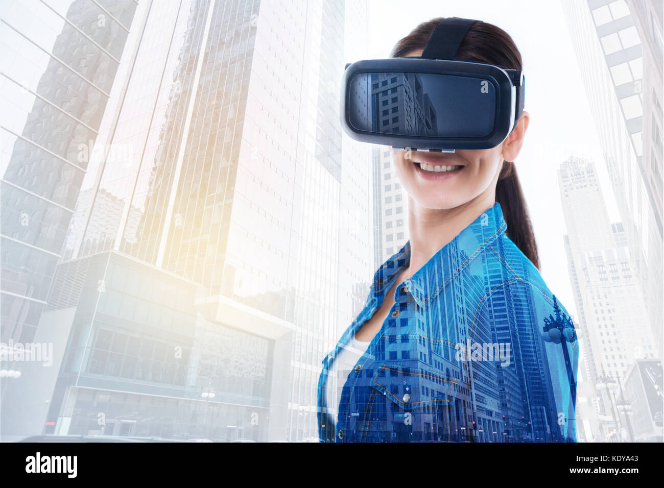 Charming woman in VR headset smiling at camera Stock Photo - Alamy