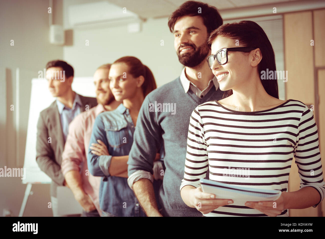 Joyful positive people standing behind each other Stock Photo Alamy