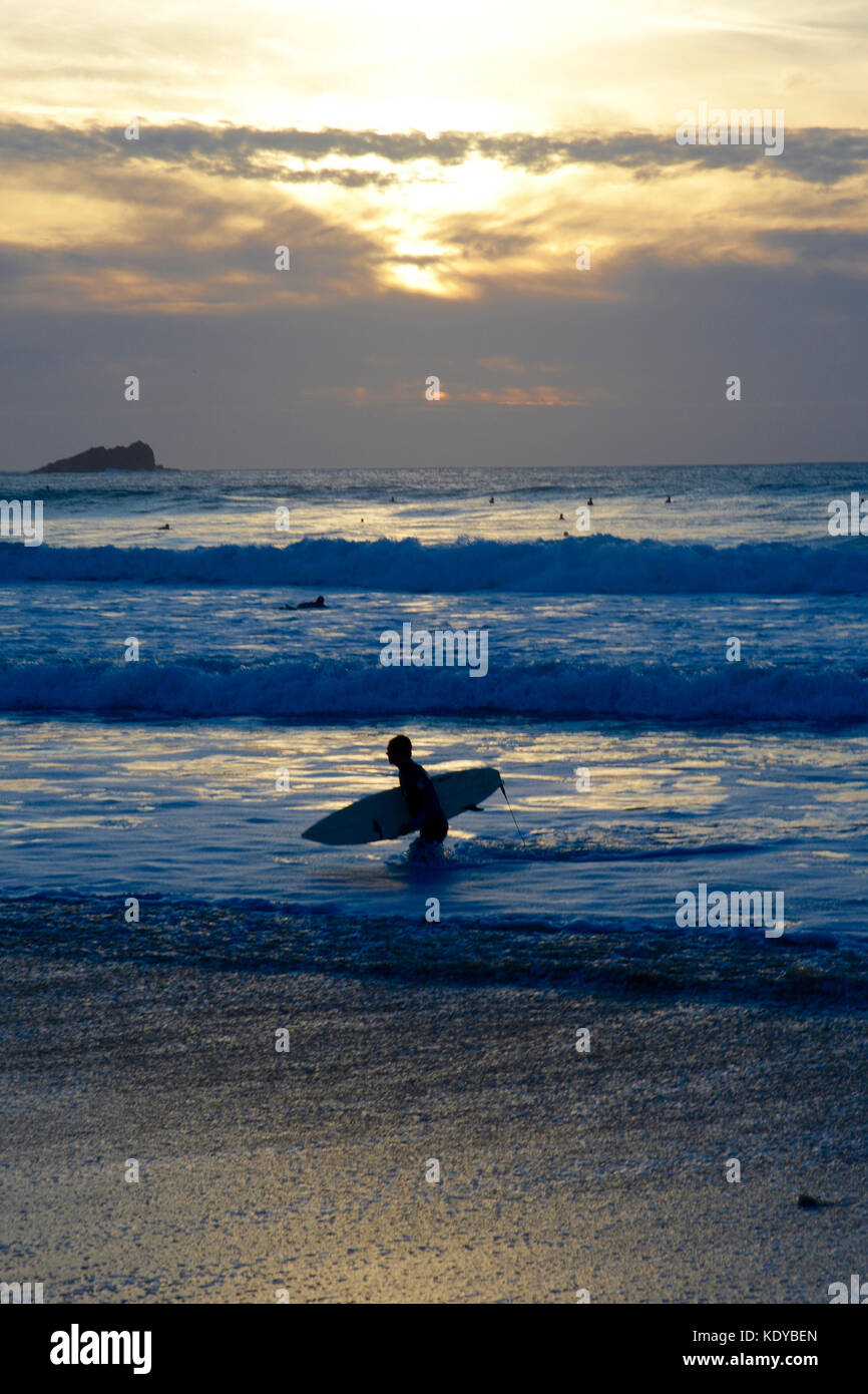 Surfers at Sunset Fistral Beach, Newquay, Cornwall Stock Photo