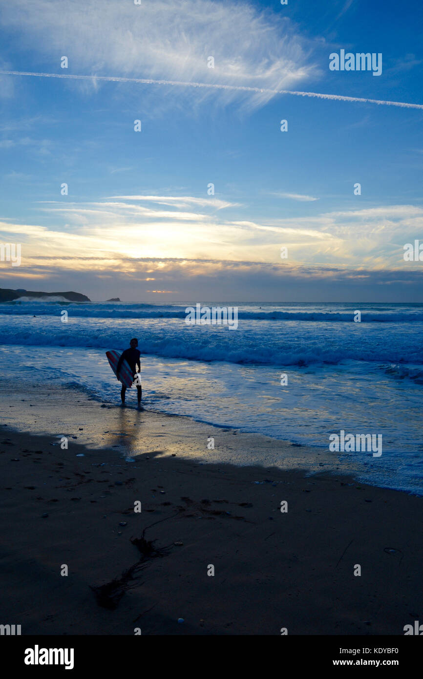 Surfers at Sunset Fistral Beach, Newquay, Cornwall Stock Photo