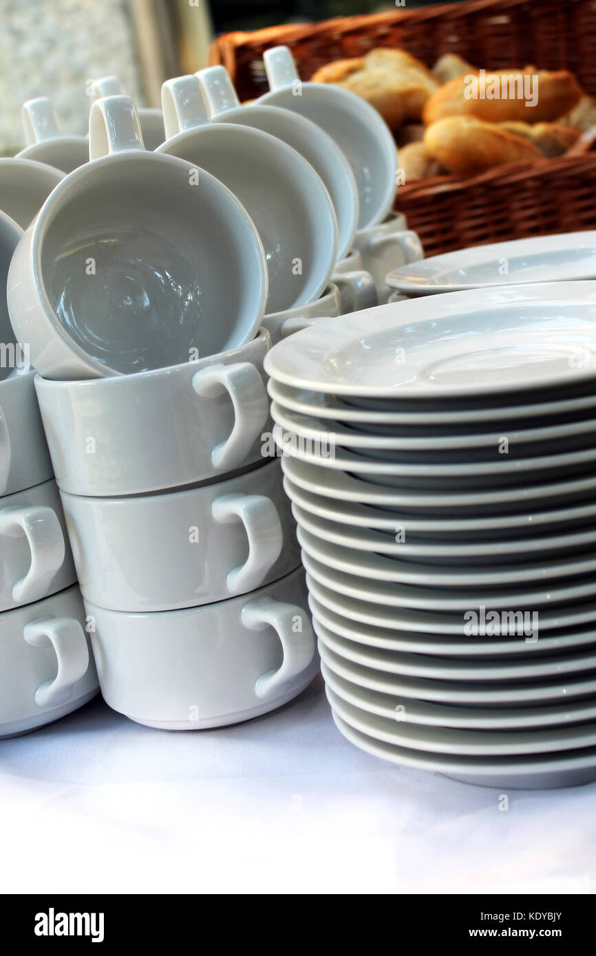 White plates and soup cups at a restaurant Stock Photo Alamy