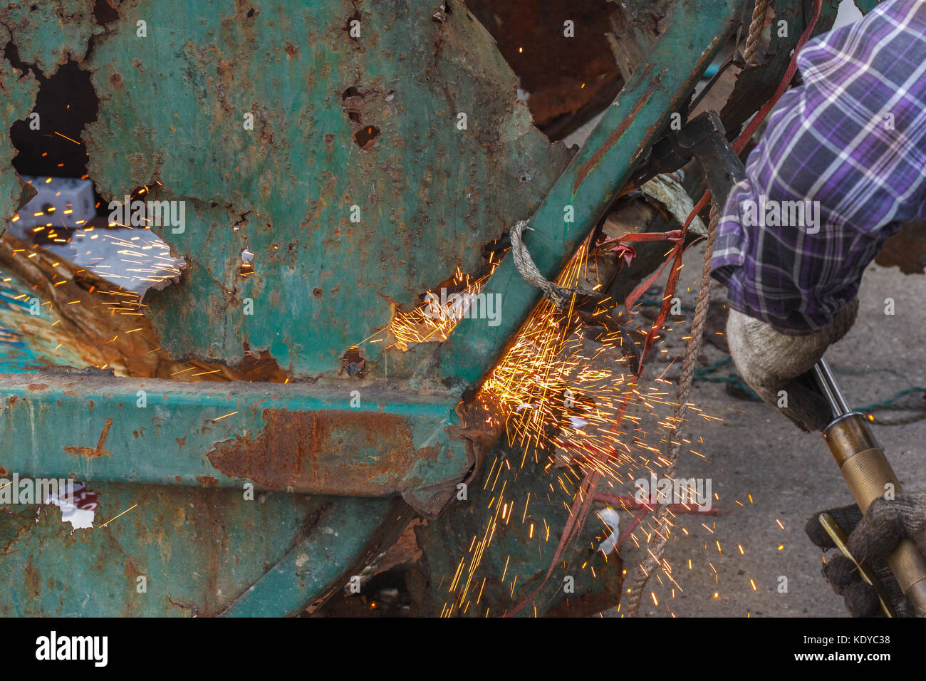 welder worker with cutting torch cutting a steel oxygen propane cutting